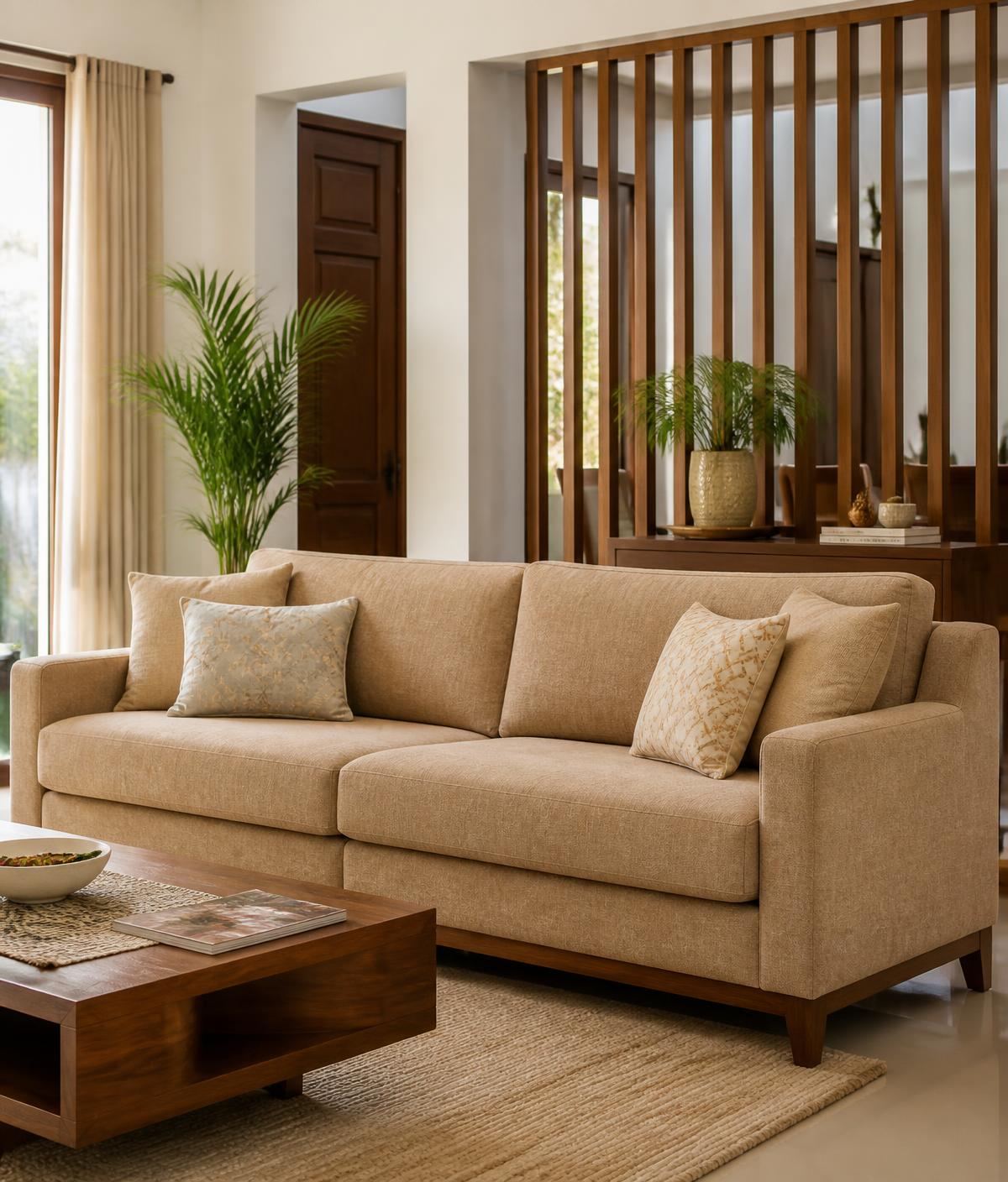 Beautifully restored camel-toned fabric sofa in a warm, modern Indian living room